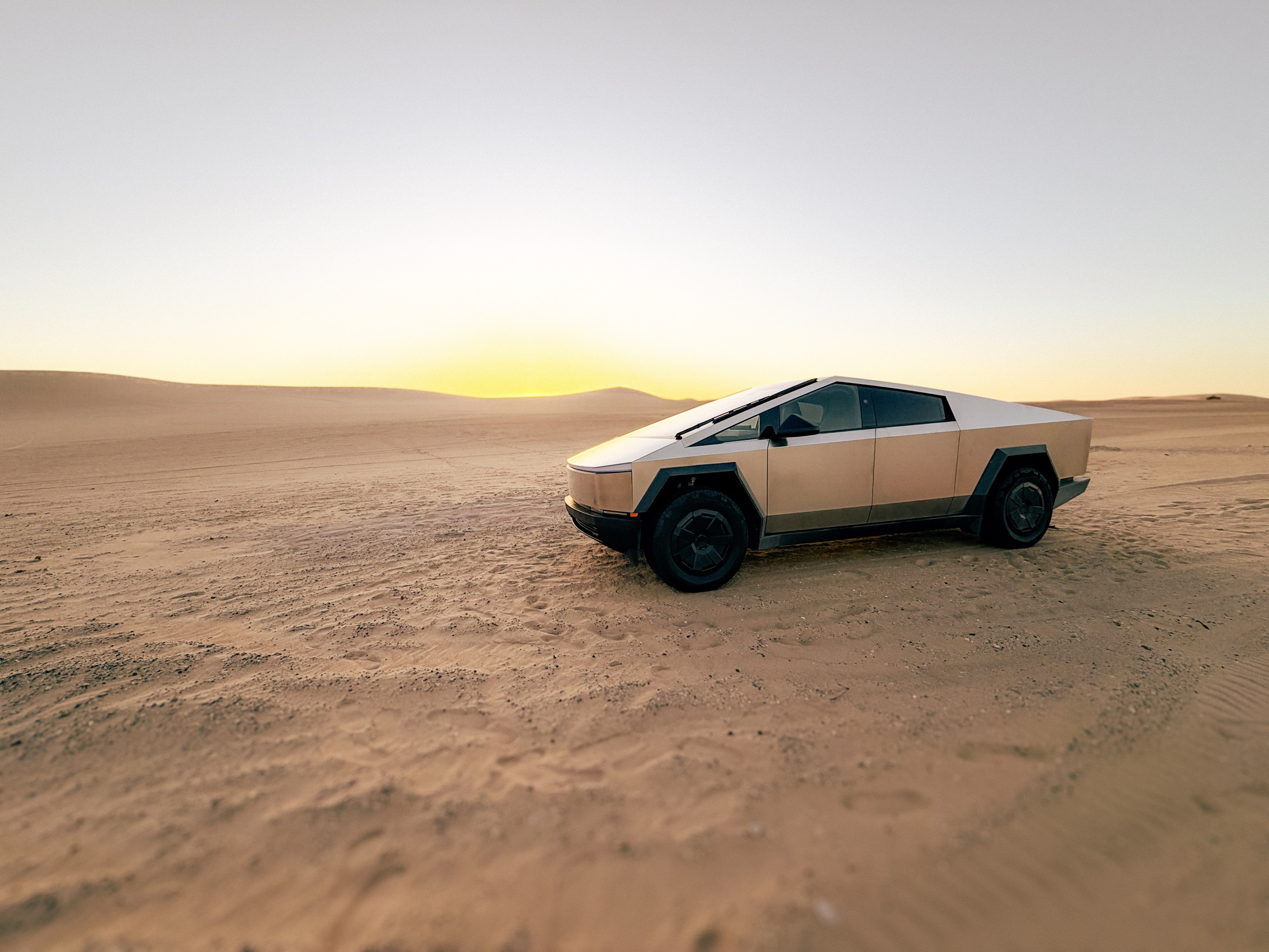 The Weekend Gold Cybertruck in the desert at sunset